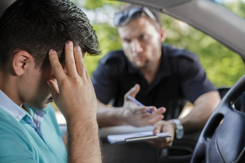 Traffic cop is talking with a driver